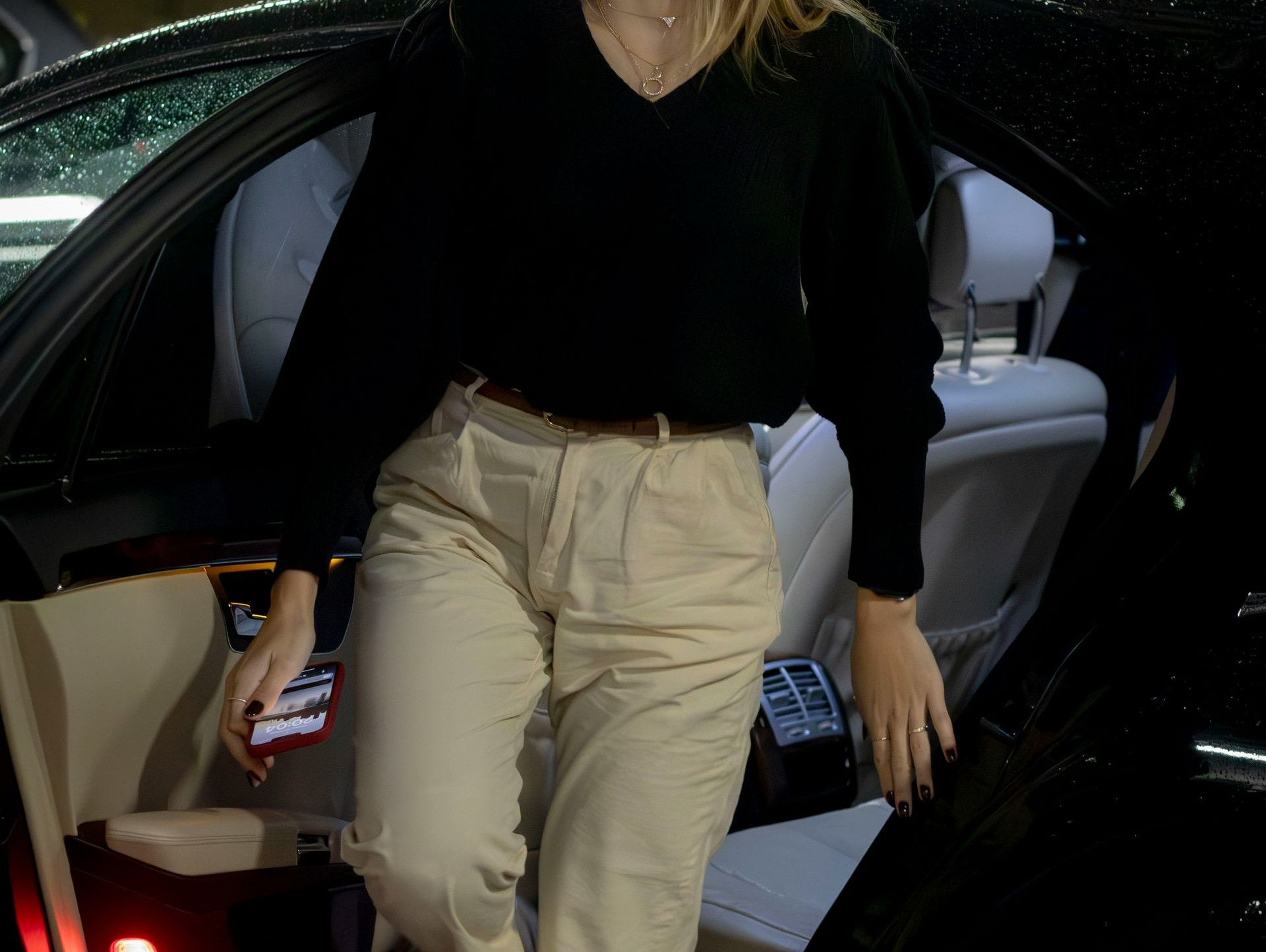 a woman walking out of a car in a parking garage